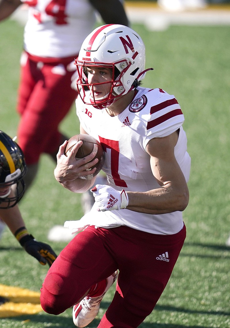 Nebraska quarterback Luke McCaffrey (7) runs from Iowa linebacker Jack Campbell (31) during an NCAA college football game, Friday, Nov. 27, 2020, in Iowa City, Iowa. (AP Photo/Charlie Neibergall)
