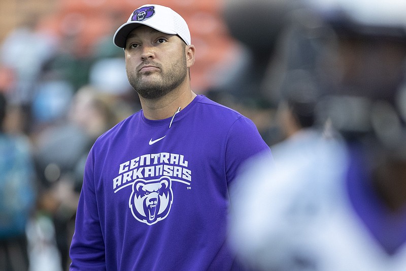 Central Arkansas head coach Nathan Brown looks up at the stands as he walks onto the field before an NCAA college football game against Hawaii, Saturday, Sept. 21, 2019, in Honolulu. (AP Photo/Eugene Tanner)