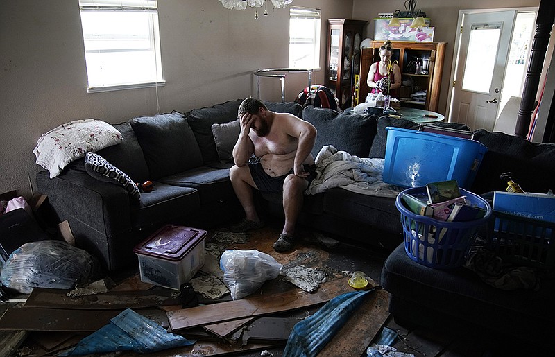 Josh Montford pauses Wednesday in his flood-damaged home in Jean Lafitte, La. “I’m overwhelmed,” he said as he searched for items to salvage. More photos at arkansasonline.com/92ida/.
(AP/John Locher)