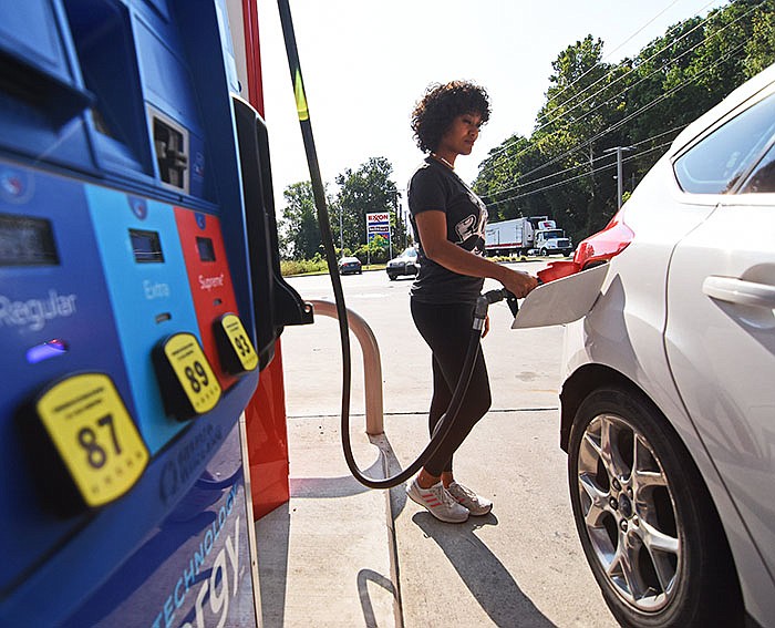 Zoe Keith of Little Rock fills up her car Wednesday morning at the DoubleBee’s Exxon gas station on Cantrell Road in Little Rock. Many people will be taking to the road for the Labor Day holiday this weekend.
(Arkansas Democrat-Gazette/Staci Vandagriff)