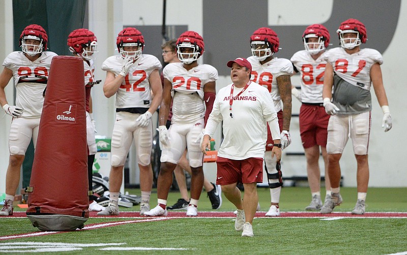 Dowell Loggains (front), who played at Arkansas in 2000-04, spent 16 years as an assistant coach with six NFL teams before returning to Fayetteville this season to be the Razorbacks’ tight ends coach. “Coaching is coaching,” Loggains said. “If you can help guys get better, they’re going to listen to you.”
(NWA Democrat-Gazette/Andy Shupe)
