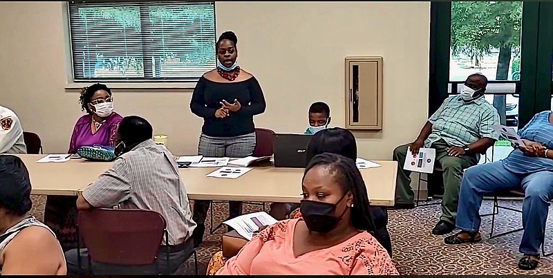 Dominique Graydon, community relations officer with the Pine Bluff Police Department, addresses residents during Tuesday’s meeting. 
(Pine Bluff Commercial/Eplunus Colvin)