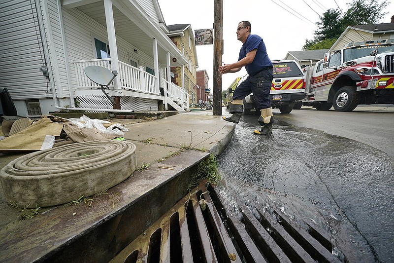 Cleanup continues from flooding on Baldwin Street in Bridgeville, Pa., on Wednesday, Sept. 1, 2021, after downpours and high winds from the remnants of Hurricane Ida hit the area. (AP/Gene J. Puskar)