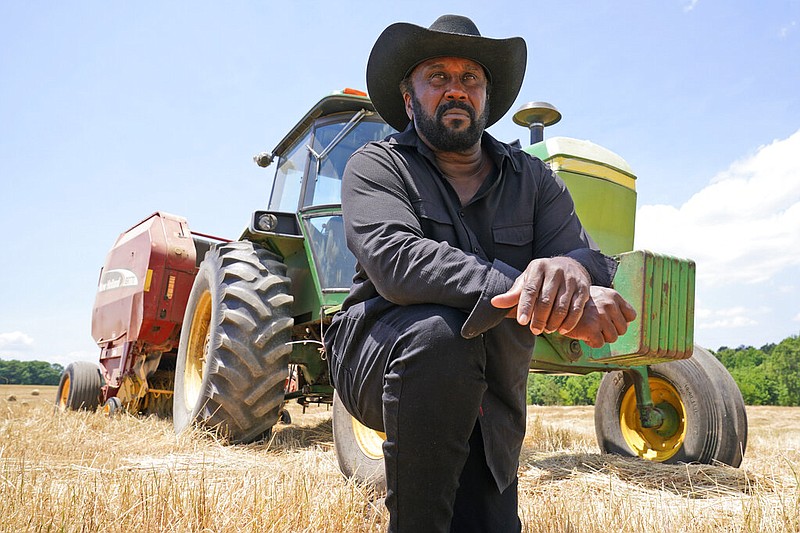 Farmer John Boyd Jr., poses for a portrait during a break from bailing hay at his farm in Boydton, Va., Thursday, May 27, 2021. (AP/Steve Helber)