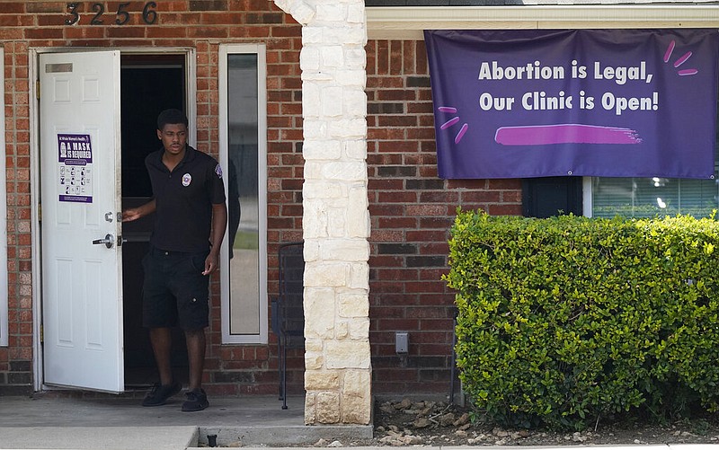 A security guard opens the door to the Whole Women's Health Clinic in Fort Worth on Wednesday, Sept. 1, 2021. A Texas law banning most abortions in the state took effect at midnight, but the clinic kept a sign outside because, at the time, the Supreme Court had yet to act on an emergency appeal to put the law on hold. The law is the most dramatic restriction on abortion rights in the United States since the high court's landmark Roe v. Wade decision legalized abortion across the country in 1973. (AP/LM Otero)