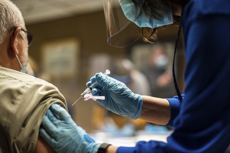 An employee gets a coronavirus vaccination in February at Tyson Foods’ Wilkesboro, N.C., plant.
(AP)