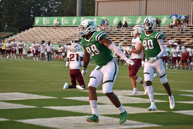 UAM tight end DeAndre Washington (88) does an end-zone dance on Thursday after making a touchdown catch in the second quarter against Southern Nazarene in Monticello. Following after Washington is UAM wideout Isaiah Cross (80). 
(Pine Bluff Commercial/I.C. Murrell)