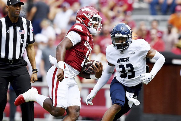 Arkansas quarterback KJ Jefferson (1) runs past Rice defender Myron Morrison (33) to score a touchdown during the first half of a game, Saturday, Sept. 4, 2021, in Fayetteville. (AP Photo/Michael Woods)