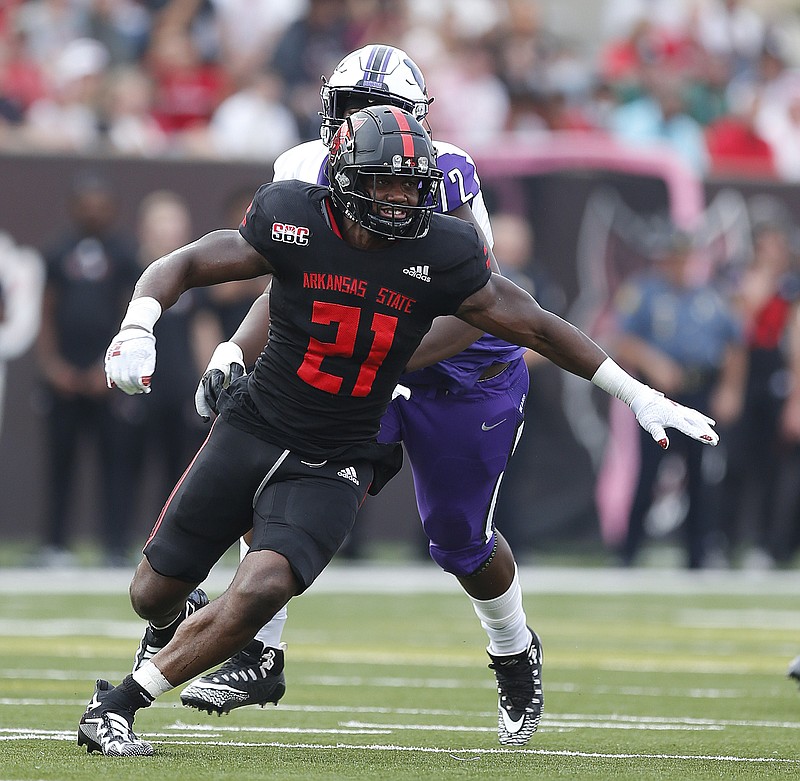 Arkansas State defensive end Joe Ozougwu (21) races around Central Arkansas offensive lineman Bakarius Collier (72) during the first quarter of the Red Wolves' 40-21 win on Saturday, Sept. 4, 2021, at Centennial Bank Stadium in Jonesboro. .(Arkansas Democrat-Gazette/Thomas Metthe)