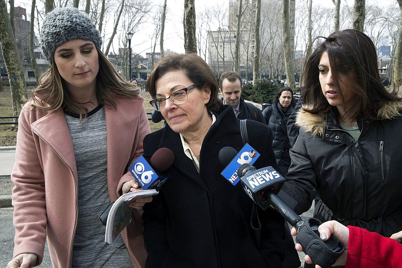 Nancy Salzman (center) is surrounded by reporters as she arrives at Brooklyn federal court in New York in this March 13, 2019, file photo. Salzman was a co-founder of the cult-like NXIVM group. (AP/Mary Altaffer)