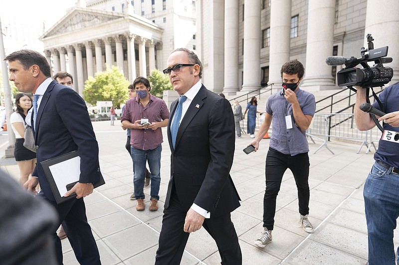 Igor Fruman (center) leaves federal court Friday in Manhattan with his attorney Todd Blanche (left).
(AP/Mary Altaffer)