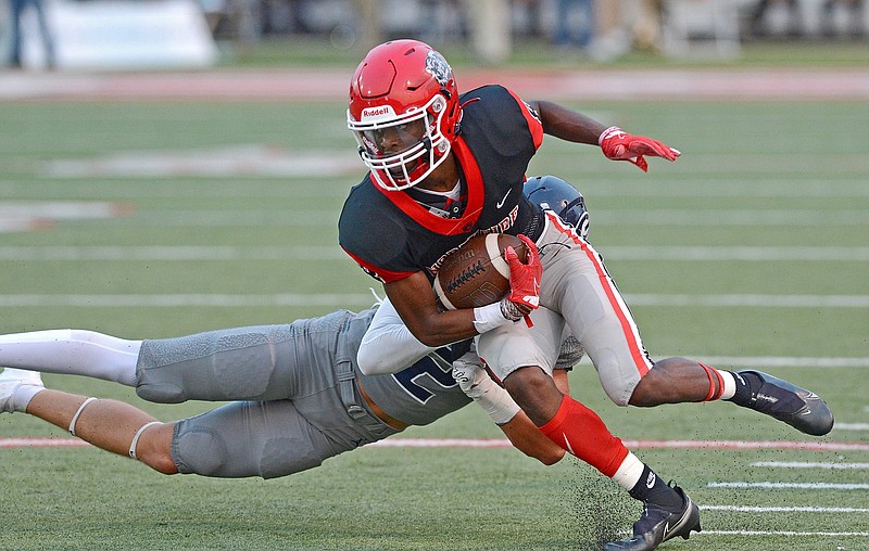 Fort Smith Northside’s Damari Smith is pulled down by Greenwood’s Storm Scherrey after making a reception during Friday night’s game. More photos available at arkansasonline.com/911ghsfsn.
(Special to the NWA Democrat-Gazette/Brian Sanderford)