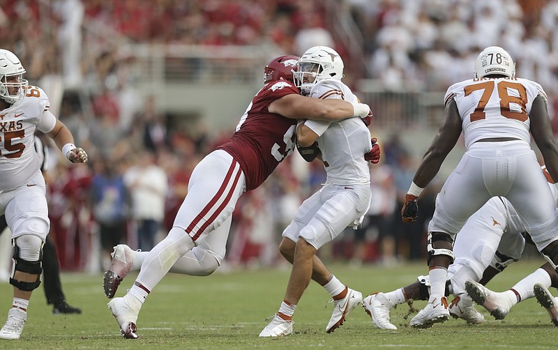 Arkansas defensive lineman John Ridgeway (99) stops Texas quarterback Hudson Card (1), Saturday, September 11, 2021 during the second quarter of a football game at Reynolds Razorback Stadium in Fayetteville. Check out nwaonline.com/210912Daily/ for today's photo gallery. .(NWA Democrat-Gazette/Charlie Kaijo)