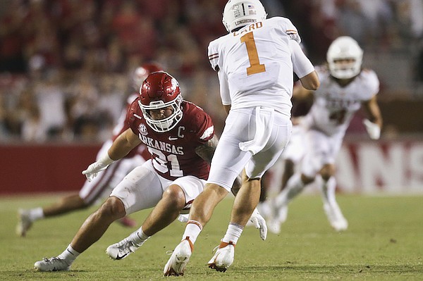 Arkansas linebacker Grant Morgan (31) tackles Texas quarterback Hudson Card during a game Saturday, Sept. 11, 2021, in Fayetteville. Arkansas linebacker Grant Morgan (31) tackles Texas quarterback Hudson Card during a game Saturday, Sept. 11, 2021, in Fayetteville.