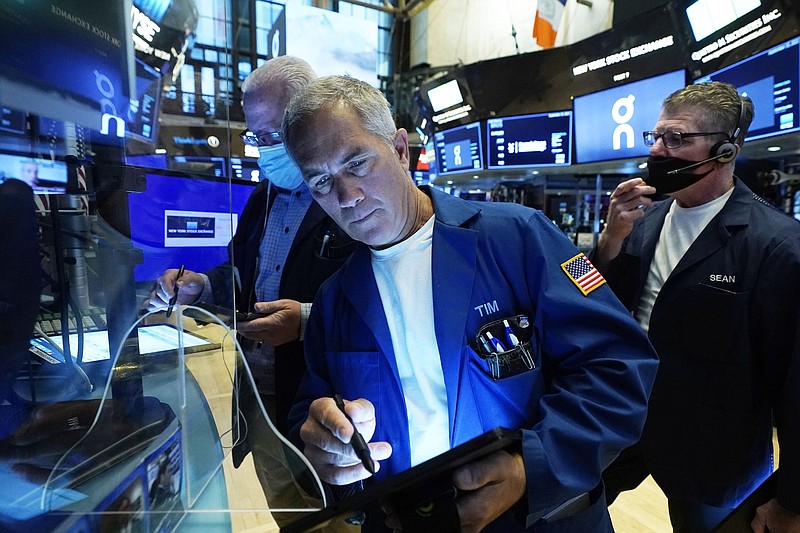 Trader Timothy Nick (center) works on the floor of the New York Stock Exchange, on Wednesday. Technology and energy company stocks pushed stocks higher on Wall Street Wednesday.
(AP/Richard Drew)