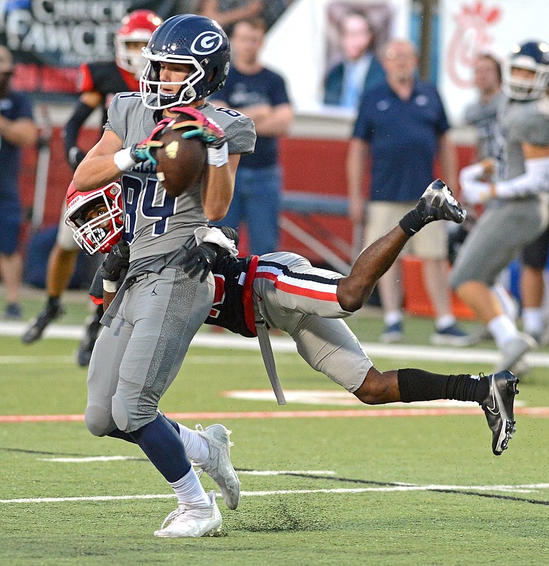 Greenwood wide receiver Luke Brewer is tackled by Fort Smith Northside safety Zavian Zeffer during Friday night’s game in Fort Smith. Zeffer had 13 tackles in the Grizzlies’ 29-20 win over the Bulldogs.
(Special to the NWA Democrat-Gazette/Brian Sanderford)