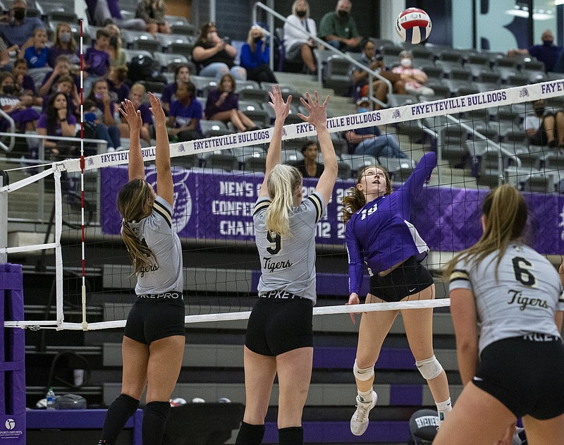 Madeline Lafata(16) goes up for spike against London McKinney (14) and Gloria Cranney (9) of Bentonville at Fayetteville High School , Fayetteville, AR, on Tuesday, September 14, 2021. (Special to NWA Democrat-Gazette/David Beach)