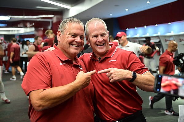 Arkansas football coach Sam Pittman (left) and athletics director Hunter Yurachek celebrate following a 40-21 victory over Texas on Saturday, Sept. 11, 2021, in Fayetteville.