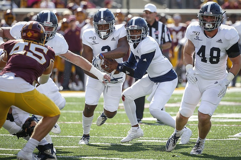 Georgia Southern quarterback Justin Tomlin (17) rides out a fake on a triple option play during a game last season. Arkansas’ defenders have taken a quick course in the triple option in preparation for Saturday’s game against the Eagles.
(AP file photo)