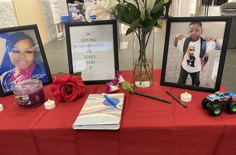 A memorial is set up at the Walmart on Cantrell Road in Little Rock on Thursday, Sept. 16, 2021. The memorial honors Shunterris Salter (left) and her 8-year-old son, Jamichael Petty, both of whom were victims of a double homicide a day earlier. Salter was an employee at the store. (Arkansas Democrat-Gazette/Teresa Moss)