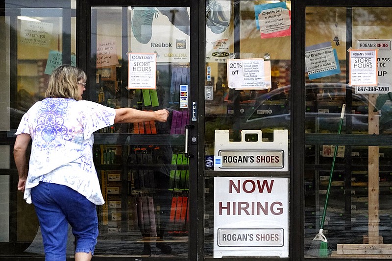 A hiring sign is displayed outside a retail store in this June 24, 2021, file photo. (AP/Nam Y. Huh)