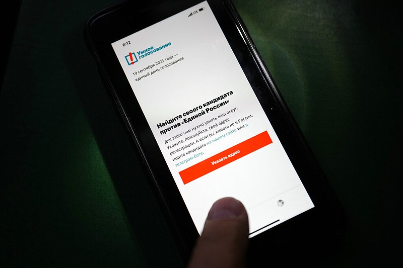 The app Smart Voting is displayed on an iPhone screen in Moscow on Friday, Sept. 17, 2021. Facing Kremlin pressure, Apple and Google on Friday removed from their online stores an opposition-created smartphone app that tells voters which candidates are likely to defeat those backed by Russian authorities. (AP/Alexander Zemlianichenko)