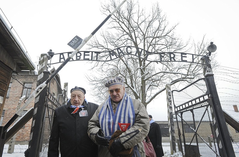 Holocaust survivors walk outside the gate of the Auschwitz Nazi death camp in Oswiecim, Poland in 2015, 70 years after prisoners there were liberated by the Soviet Red Army. An exhibit in Kansas City, “Auschwitz. Not long ago. Not far away” opened June 14.
(AP/Alik Keplicz)