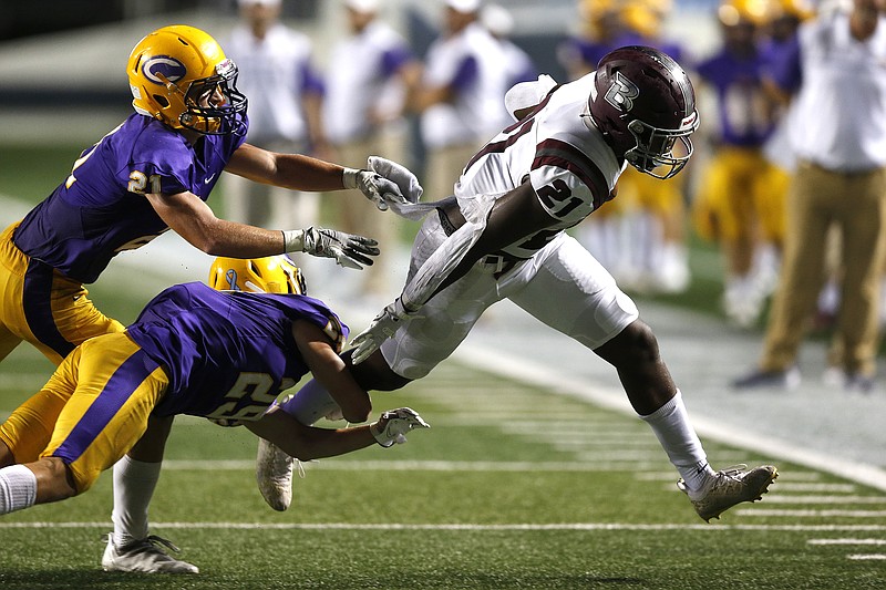 Benton's Jadin Collinet (right) tries to shake off Little Rock Catholic defensive backs Cade McConnell (center) and Cole Pace (left) during the second quarter of the Panthers' 40-7 win on Friday, Sept. 17, 2021, at War Memorial Stadium in Little Rock. .More photos at www.arkansasonline.com/918catben/.(Arkansas Democrat-Gazette/Thomas Metthe)
