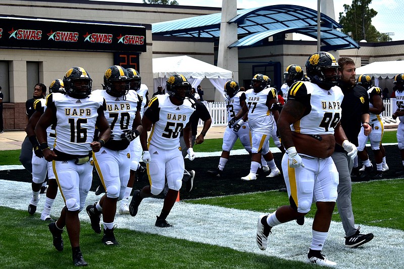 Football players with the University of Arkansas at Pine Bluff Golden Lions take the field in this undated file photo. (Pine Bluff Commercial/I.C. Murrell)