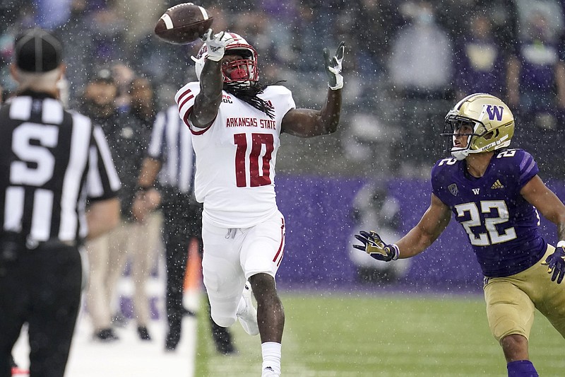 Arkansas State wide receiver Te’Vailance Hunt (left) can’t come up with the catch on a pass thrown by quarterback James Blackman as Washington defensive back Trent McDuffie defends in the first half Saturday afternoon at Husky Stadium in Seattle. More photos are available at arkansasonline.com/919asuwu/
(AP/Elaine Thompson)