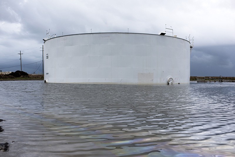 An oil tank is surrounded by water in September after Hurricane Ida near Cocodrie, La.
(Bloomberg (WPNS)/Mark Felix)