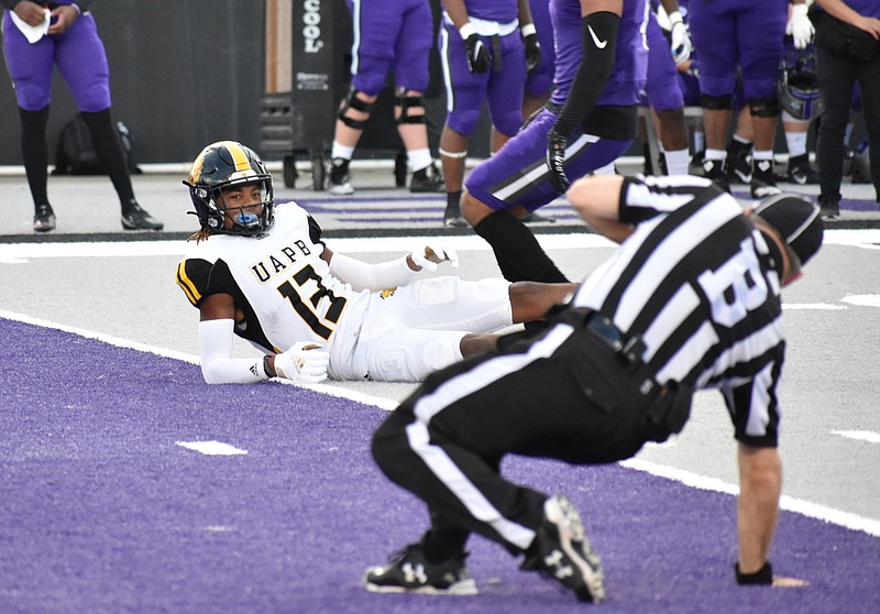 UAPB wide receiver DeJuan Miller looks at back judge Greg Laurentius, who loses his footing after an incomplete pass against Central Arkansas on Saturday at First Security Field in Conway. 
(Pine Bluff Commercial/I.C. Murrell)