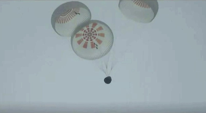 A SpaceX capsule carrying four people parachutes on Saturday into the Atlantic Ocean off the Florida coast.
(AP/SpaceX)