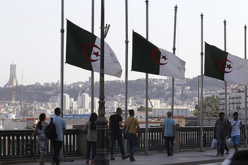 Algerian flags fly at half-staff Saturday along the seaside walk in Algiers.
(AP/Fateh Guidoum)
