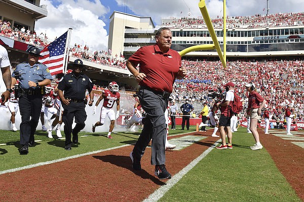 Arkansas coach Sam Pittman leads his team onto the field to play Georgia Southern during the first half of an NCAA college football game Saturday, Sept. 18, 2021, in Fayetteville. (AP Photo/Michael Woods)