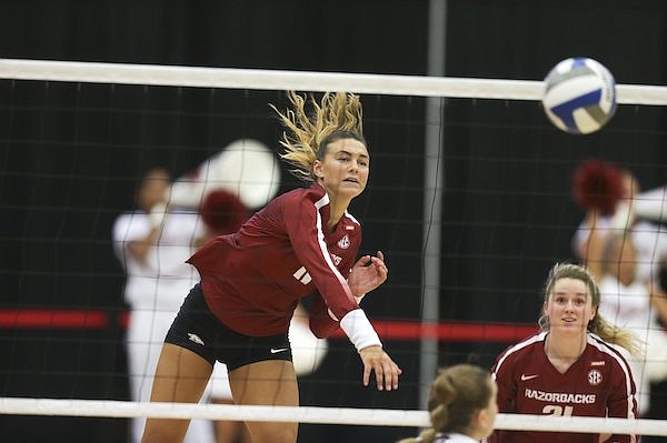 Arkansas outside hitter Maggie Cartwright (11) spikes a ball during a game against Arkansas-Little Rock on Saturday, Aug. 28, 2021, in Fayetteville.