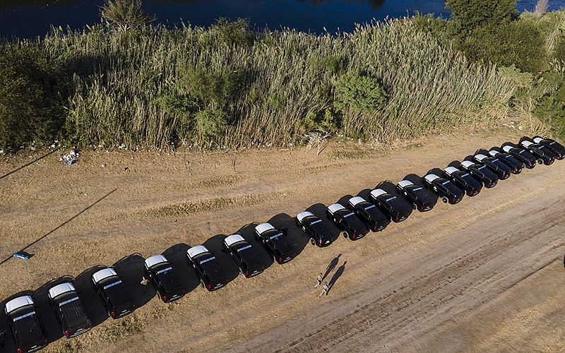 Texas Department of Safety vehicles line the bank of the Rio Grande on Wednesday near an encampment of migrants in Del Rio, Texas. The camp held more than 14,000 people, many of them Haitians, over the weekend. U.S. authorities have declined to say how many have been released inside the U.S. in recent days.
(AP/Julio Cortez)