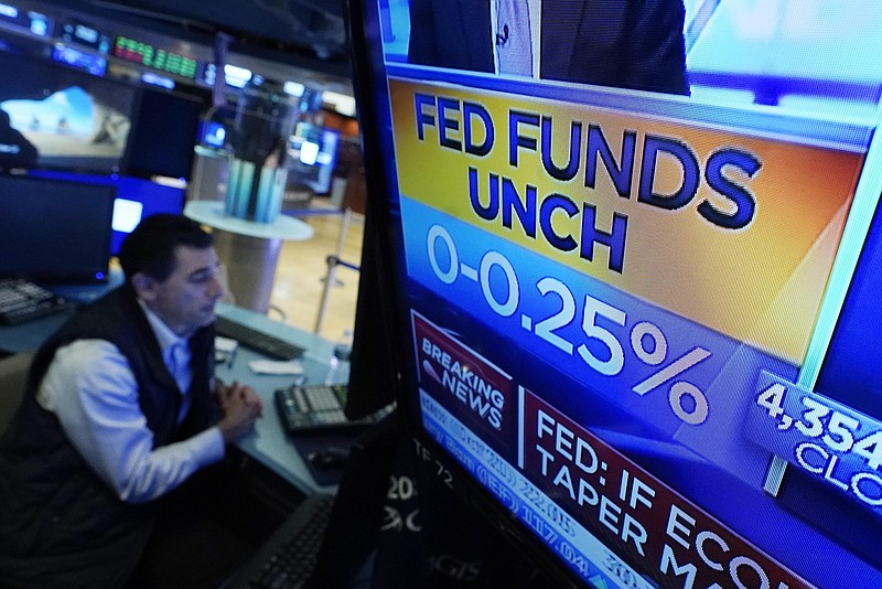 A video screen on the floor of the New York Stock Exchange on Wednesday shows the Federal Reserve’s rate decision. The Fed signaled that it may start raising its benchmark interest rate next year.
(AP/Richard Drew)