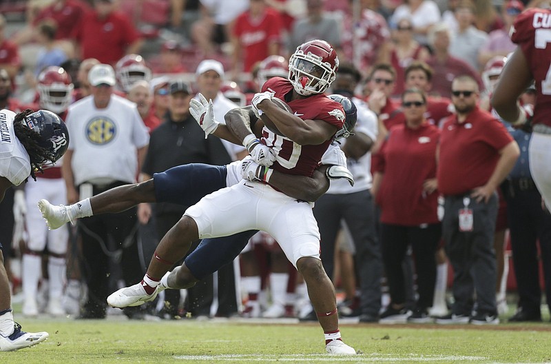 Arkansas running backs Dominique Johnson (shown, 20) and Trelon Smith are key parts of the Razorbacks’ improved rushing attack and are joined by freshmen Raheim Sanders and AJ Green. Johnson and Smith each have ran for a touchdown in the first three games, the first Hogs tandem to do that in 18 years.
(NWA Democrat-Gazette/Charlie Kaijo)