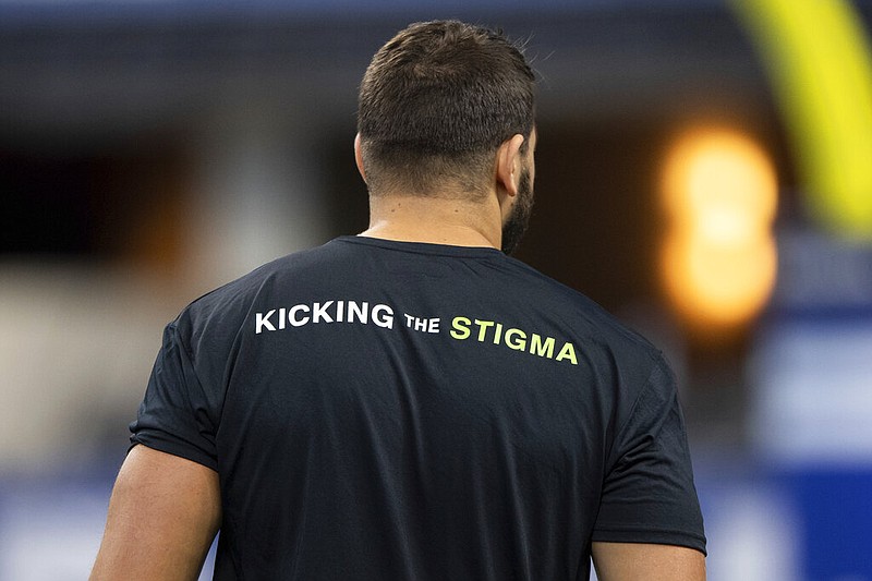 An Indianapolis Colts player wears a shirt promoting mental-health awareness during an NFL game against the Los Angeles Rams in Indianapolis in this Sept. 19, 2021, file photo. The team and its owners said in a news release that they are continuing to raise awareness about mental illnesses and remove the stigma about problems with mental health. (AP/Zach Bolinger)