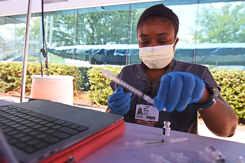 Mya Baker, a pharmacist for the University of Arkansas for Medical Sciences, prepares doses of the Pfizer coronavirus vaccine during the job fair and vaccine clinic hosted by the City of North Little Rock on Wednesday, Sept. 22, 2021, at the Chamber of Commerce. (Arkansas Democrat-Gazette/Staci Vandagriff)