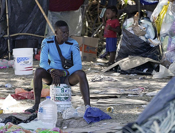 A man sits in the encampment Thursday under the Del Rio International Bridge, where as many as 15,000 migrants, many from Haiti, had been staying after crossing from Mexico into Texas.
(AP/Julio Cortez)