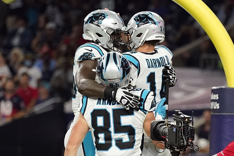 Carolina Panthers quarterback Sam Darnold (right) is congratulated by teammates Cameron Erving (left) and Dan Arnold after his touchdown run during Thursday’s night’s victory over the Houston Texans. More photos available at arkansasonline.com/924nctx.
(AP/Eric Christian Smith)