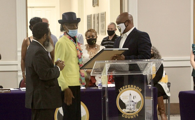 Justice of the Peace Alfred Carroll (left) and Jefferson County Judge Gerald Robinson (right) presented the first Black Jefferson County employee, Gladys Smith (center) with an Office of the County Judge Proclamation for her lifelong commitments, selfless acts of compassion and courage. 
(Pine Bluff Commercial/Eplunus Colvin)