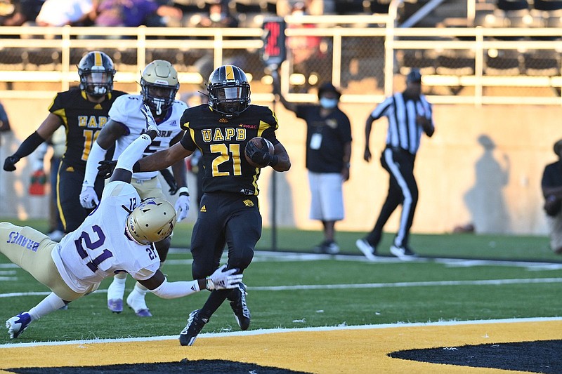 Kierre Crossley (21), University of Arkansas at Pine Bluff running back, runs through a tackle by Alcorn State’s Juwan Taylor to score a touchdown during the Golden Lions’ 39-38 loss at Simmons Bank Field in Pine Bluff in this Thursday, Sept. 23, 2021 file photo. (Special to The Commercial/Darlena Roberts)
