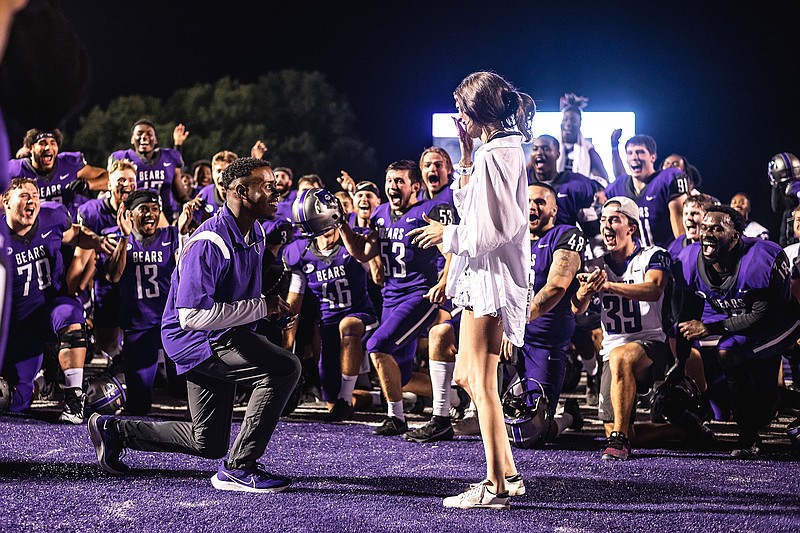 University of Central Arkansas graduate assistant DeAirus Whitney proposes to his girlfriend, Macie Fritts, surrounded by the Bears’ football team after Saturday’s victory over UAPB.
(Photo courtesy of the University of Central Arkansas)
