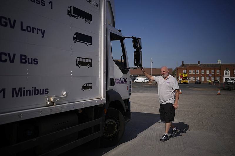 Instructor Graham Bolger directs trainee Cadhene Lubin-Hewitt as he reverses a truck at the National  Driving Centre in Croydon, London, on Wednesday. Britain doesn’t have enough truck drivers, contributing to a scarcity of everything from McDonald’s milkshakes to supermarket produce. Video at arkansasonline.com/925ukfuel/. 
(AP/Matt Dunham)