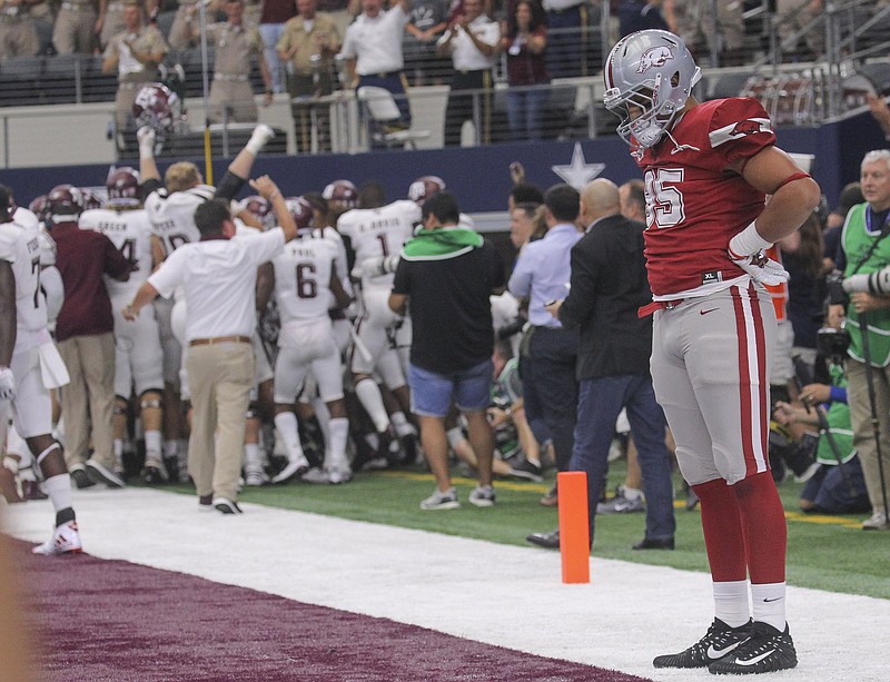 Arkansas tight end C.J. O’Grady stands dejectedly in the end zone at AT&T Stadium in Arlington, Texas, after Texas A&M’s game-ending interception in the Aggies’ overtime victory over the Razorbacks in 2017. Today, the Razorbacks will attempt to end their nine-game losing streak to the Aggies.
(Democrat-Gazette file photo)