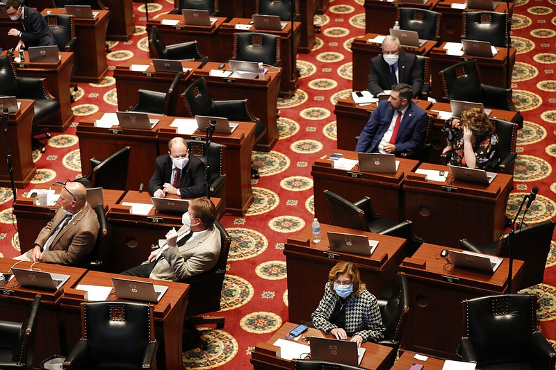 Missouri state lawmakers, many wearing masks, sit at their desks inside the House chamber of the Legislature in Jefferson City in this April 27, 2020, file photo. (AP/Jeff Roberson)