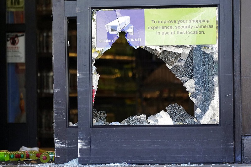 A door with broken glass stands open in the entrance of a Kroger grocery store in Collierville, Tenn., on Friday, Sept. 24, 2021. Police say a gunman, who has been identified as a third-party vendor to the store, attacked people Thursday and killed at least one person and wounded others before being found dead of an apparent self-inflicted gunshot wound. (AP/Mark Humphrey)